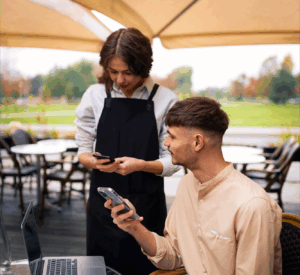 A customer paying for his meal with PAYSPOS handheld device